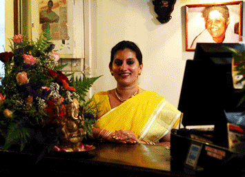 Founder of Swaadhisht, Mrs Bindu Anil, smiling behind the counter